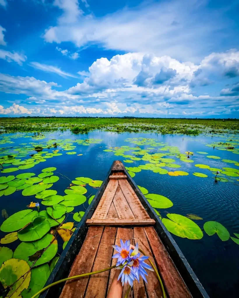 Girl Sitting in Boat AI Photo Editing Prompt - Same face Same outfit: Ultrawide upper-angle low-angle shot